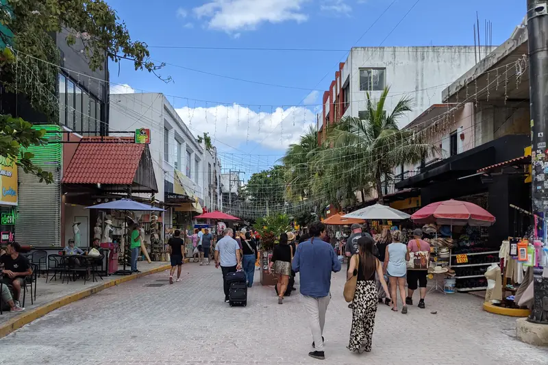 Travelers walking along Quinta Avenida in Playa del Carmen